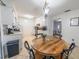 Charming kitchen featuring a round wooden dining table set with four chairs and adjacent white appliances at 2140 Ne 40Th St, Ocala, FL 34479