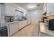 Traditional kitchen with tiled backsplash, white cabinets, and stainless steel appliances at 2140 Ne 40Th St, Ocala, FL 34479