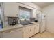 Traditional kitchen featuring white cabinets, tiled backsplash, and modern appliances at 2140 Ne 40Th St, Ocala, FL 34479