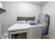 Functional laundry area featuring a modern washer and dryer set with a water heater at 2140 Ne 40Th St, Ocala, FL 34479