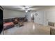 Open living room with tile flooring, ceiling fan, and comfortable seating area at 2140 Ne 40Th St, Ocala, FL 34479