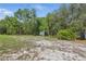 Image shows a storage shed in the backyard surrounded by trees at 22189 Sw Neptune Blvd, Dunnellon, FL 34431