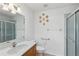 A bright bathroom with a vanity, toilet, shower, and decoratively-placed plates at 22189 Sw Neptune Blvd, Dunnellon, FL 34431