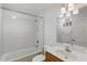 Bright bathroom featuring tub/shower combination and a vanity with a sink and a mirror at 22189 Sw Neptune Blvd, Dunnellon, FL 34431