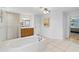 Spacious bathroom featuring a soaking tub, wooden vanity, and tiled floors at 22189 Sw Neptune Blvd, Dunnellon, FL 34431