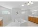 Bright and open bathroom featuring a tub, a shower, and vanity storage at 22189 Sw Neptune Blvd, Dunnellon, FL 34431