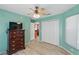 Inviting bedroom with a ceiling fan, closet, and views of the home's interior at 22189 Sw Neptune Blvd, Dunnellon, FL 34431