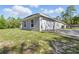 A charming home exterior with a well-kept lawn, a fenced-in yard, and an attached garage at 22189 Sw Neptune Blvd, Dunnellon, FL 34431