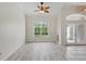 Well-lit open room features hardwood floors, double doors, and a large window to let the sunshine in at 22189 Sw Neptune Blvd, Dunnellon, FL 34431