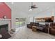 Open-concept living room featuring wood floors, fireplace, and seamless flow to the modern kitchen at 22189 Sw Neptune Blvd, Dunnellon, FL 34431