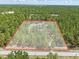 Aerial image outlining property boundaries, highlighting the home's spacious lot amidst trees at 22189 Sw Neptune Blvd, Dunnellon, FL 34431