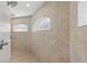 Modern shower featuring multiple shower heads and horizontal windows for natural light at 22189 Sw Neptune Blvd, Dunnellon, FL 34431