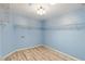 A walk-in closet featuring an organizational system, neutral walls, and wood-look flooring at 22189 Sw Neptune Blvd, Dunnellon, FL 34431