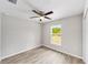 This comfortable bedroom offers a ceiling fan, wood-look floors, and a window for ample light at 25 Juniper Pass Way, Ocala, FL 34480
