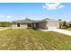 Charming single-story home featuring a well-manicured lawn and attached two-car garage at 25 Juniper Pass Way, Ocala, FL 34480