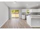 Bright kitchen features white cabinets, stainless appliances, granite counters and sliding glass door to backyard at 25 Juniper Pass Way, Ocala, FL 34480