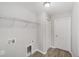 Neutral laundry room features wire shelving and wood-look floors at 25 Juniper Pass Way, Ocala, FL 34480