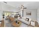 Airy living room with sleek flooring, neutral décor, and a seamless transition to dining and kitchen at 25 Juniper Pass Way, Ocala, FL 34480