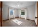 Sunny bedroom featuring two bright windows, carpet, and a ceiling fan at 2576 Ne 34Th St, Ocala, FL 34479