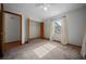 Bright bedroom featuring carpet floors, a ceiling fan and a large closet for ample storage space at 2576 Ne 34Th St, Ocala, FL 34479