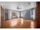 Bedroom showcasing wood-look floors, ceiling fan, blue accent wall, and natural light at 2576 Ne 34Th St, Ocala, FL 34479