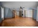 Bedroom featuring blue accent wall, wood-look floors, ceiling fan, and large closet at 2576 Ne 34Th St, Ocala, FL 34479