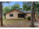 Exterior view of home with screened porch, neutral paint, and mature trees at 2576 Ne 34Th St, Ocala, FL 34479