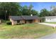 Single story brick home with an attached garage, well-kept lawn, and a cozy front porch at 2576 Ne 34Th St, Ocala, FL 34479