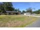 Spacious front yard showcases a single-story brick home with an extended driveway leading to a detached garage at 2576 Ne 34Th St, Ocala, FL 34479