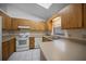 Bright kitchen featuring matching appliances, white tile floors, and wood kitchen cabinets at 2576 Ne 34Th St, Ocala, FL 34479