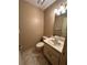 Neutral-toned half bathroom with vanity and tile flooring at 2701 Ne 10Th St # 403, Ocala, FL 34470