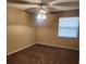 Cozy bedroom featuring a ceiling fan, plush carpeting and a bright window at 2701 Ne 10Th St # 403, Ocala, FL 34470