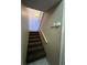 Carpeted stairway leading upstairs, featuring neutral walls and decorative lighting at 2701 Ne 10Th St # 403, Ocala, FL 34470