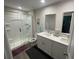 Bathroom with double vanity, large framed mirror, and walk-in shower with modern fixtures at 3338 Sw 165Th Loop, Ocala, FL 34473