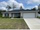 Charming single-story home features a well-manicured lawn and a two-car garage at 3338 Sw 165Th Loop, Ocala, FL 34473
