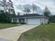 Inviting single-story home with a two-car garage and a well-maintained front lawn at 3338 Sw 165Th Loop, Ocala, FL 34473
