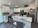 Modern kitchen featuring white cabinets, stainless steel appliances, and a center island with breakfast bar seating at 3338 Sw 165Th Loop, Ocala, FL 34473