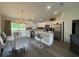 Bright kitchen features white cabinets, stainless steel appliances, and a center island at 3338 Sw 165Th Loop, Ocala, FL 34473