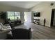 Comfortable living room with hardwood floors, large window and TV at 3338 Sw 165Th Loop, Ocala, FL 34473