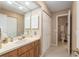 Bathroom with a single sink vanity, mirror, and toilet at 3815 Ne 17Th Street Cir, Ocala, FL 34470