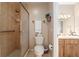 Cozy bathroom featuring a tile shower, neutral color palette, and wood vanity with storage at 3815 Ne 17Th Street Cir, Ocala, FL 34470
