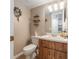 Cozy powder room featuring a decorative mirror and wooden vanity cabinet for storage at 3815 Ne 17Th Street Cir, Ocala, FL 34470