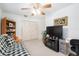 Bedroom boasts ceiling fan, closet, entertainment center, and convertible sofa at 3815 Ne 17Th Street Cir, Ocala, FL 34470