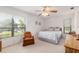 Bright bedroom with a ceiling fan and view of the yard and neighborhood at 3815 Ne 17Th Street Cir, Ocala, FL 34470