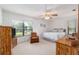 Bright bedroom with a ceiling fan and view of the yard at 3815 Ne 17Th Street Cir, Ocala, FL 34470