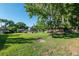 Expansive community lawn area with mature trees and landscaping near the clubhouse and pool at 3815 Ne 17Th Street Cir, Ocala, FL 34470