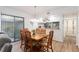 Bright dining area with a view of the courtyard and an open view into the kitchen at 3815 Ne 17Th Street Cir, Ocala, FL 34470