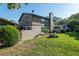 Back exterior view of a two-story townhouse with a yard, walls, and patio areas at 3815 Ne 17Th Street Cir, Ocala, FL 34470