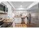 Bright kitchen with stainless steel appliances, granite counters, and a pass-through to the living area at 3815 Ne 17Th Street Cir, Ocala, FL 34470