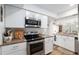 Well-lit kitchen featuring white cabinets, stainless steel appliances, and updated countertops at 3815 Ne 17Th Street Cir, Ocala, FL 34470
